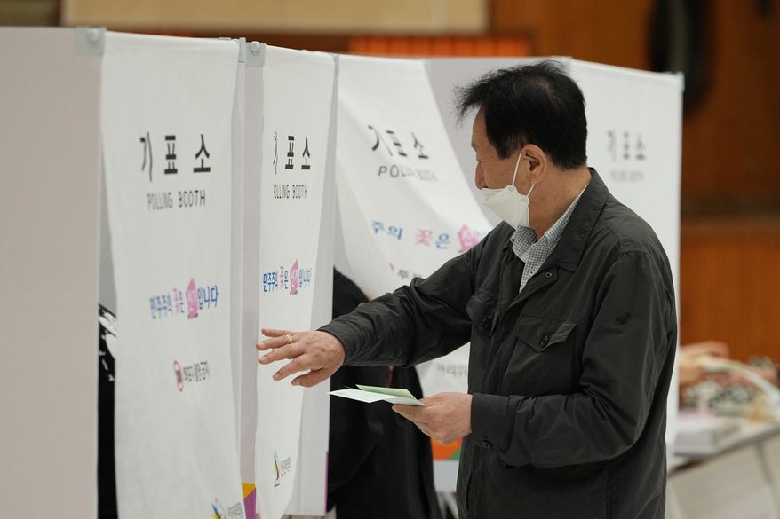 A voter arrives to cast his votes for the nationwide simultaneous local elections at a polling station in Seoul, South Korea, Wednesday, June 3, 2026. (AP Photo/Lee Jin-man)