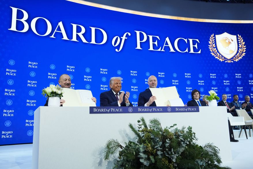 President Donald Trump, center, applauds as Ilham Aliyev, President of Azerbaijan, left, and Bulgaria's Prime Minister Rossen Jeliazkov, right, hold up their signed Board of Peace charter during the Annual Meeting of the World Economic Forum in Davos, Switzerland, Jan. 22, 2026. (AP Photo/Evan Vucci, File)