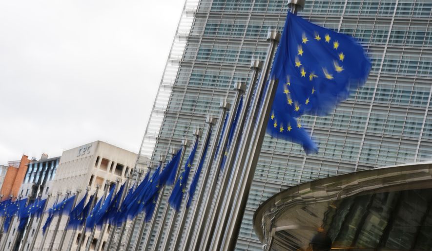 European Union flags flap in the wind outside EU headquarters in Brussels, Tuesday, May 12, 2026. (AP Photo/Virginia Mayo)