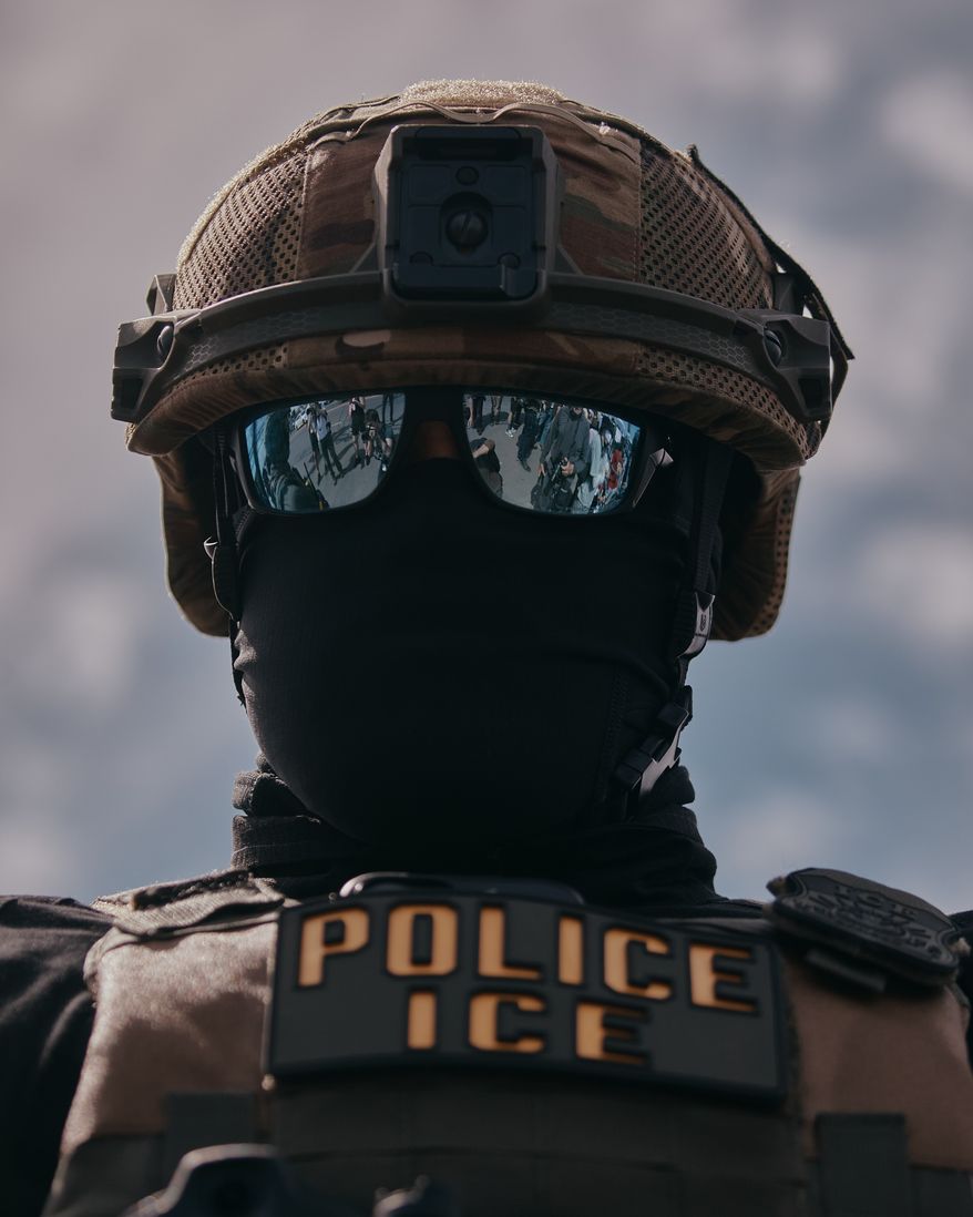 A masked ICE agent stands guard outside the Delaney Hall detention during a protest against the transfer of detainees on Tuesday, May 26, 2026, in Newark, N.J. (AP Photo/Andres Kudacki)
