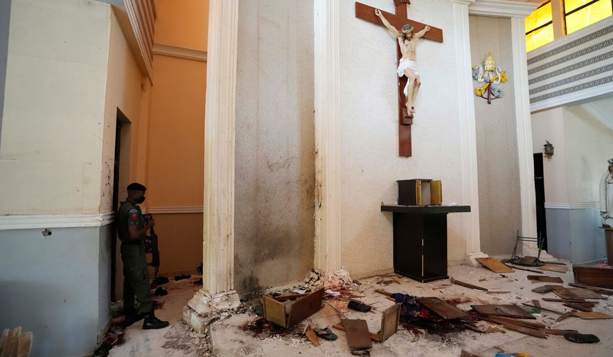 A police officer stands guard inside the St. Francis Catholic Church, a day after an attack that targeted worshipers in Owo, Nigeria, June 6, 2022. (AP Photo/Sunday Alamba, File)