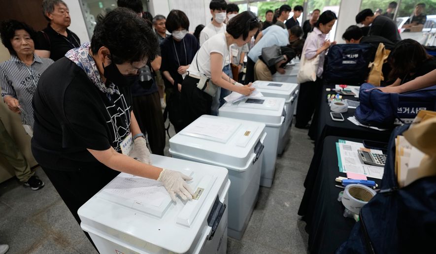 South Korean National Election Commission officials check boxes containing ballots for the local elections at a gymnasium in Seoul, South Korea, Wednesday, June 3, 2026. (AP Photo/Ahn Young-joon)