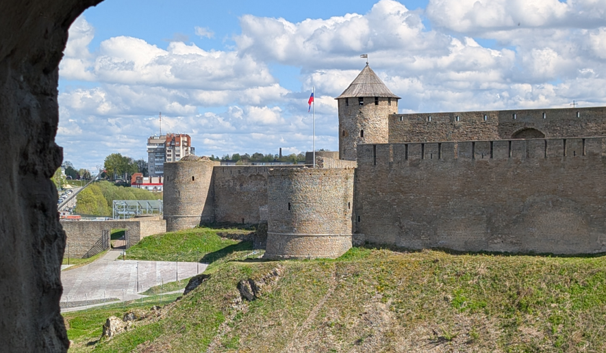 The distance across the Narva River is only 101 meters, or just over 110 yards, between the two forts. The view shown here is from inside the Narva Museum and includes the paved area where the so-called "Victory Day" concert was held, on the right side of the far embankment. (John T. Seward/The Washington Times)