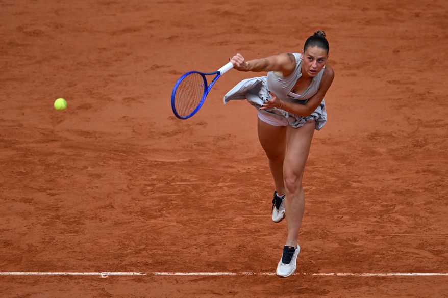 Ukraine's Marta Kostyuk serves to Russia's Mirra Andreeva during the semifinal tennis match at the French Open in Paris, Thursday, June 4, 2026. (AP Photo/Emma Da Silva)