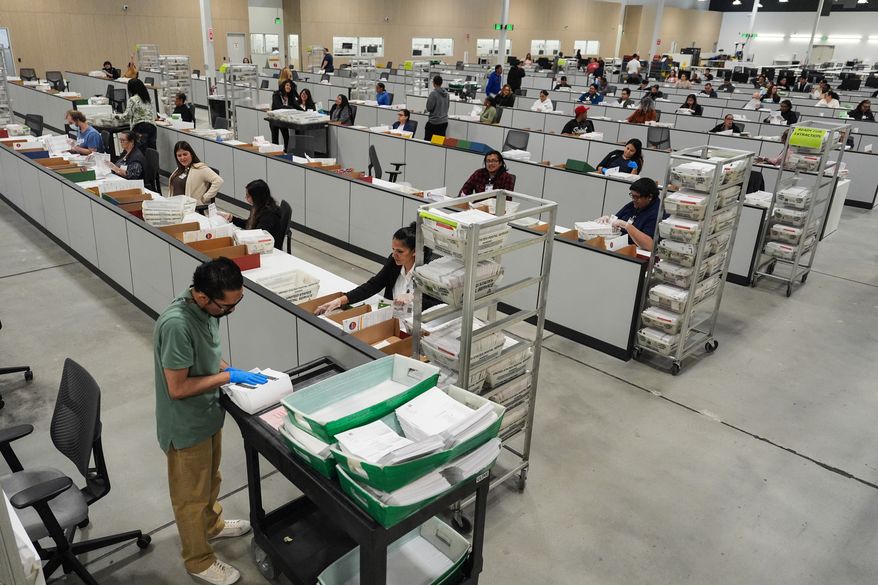 Ballots are inspected the day after California's primary election at the Los Angeles County Ballot Processing Center Wednesday, June 3, 2026, in City of Industry, Calif. (AP Photo/Jae C. Hong)