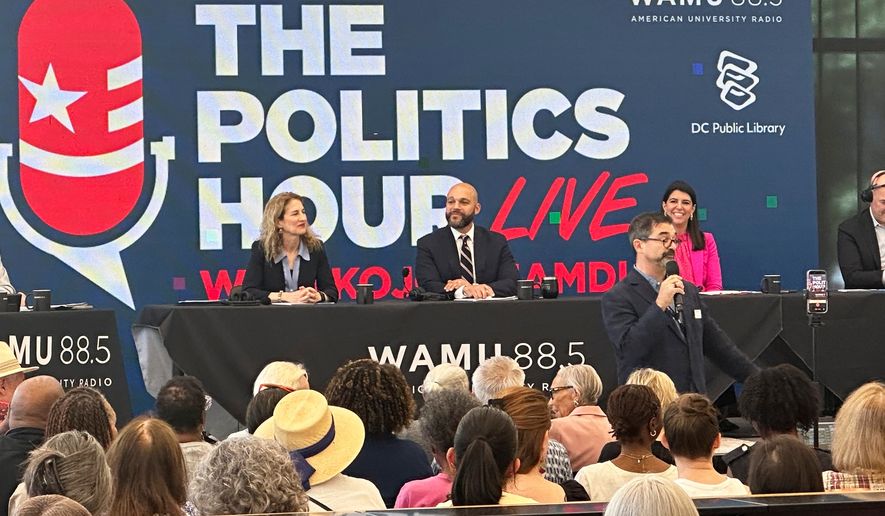 Robert White Jr., center, and Brooke Pinto, right, candidates for Washington D.C. delegate, participate in a forum at the Martin Luther King Jr. Memorial Library, Friday, May 29, 2026. (AP Photo/Gary Fields)