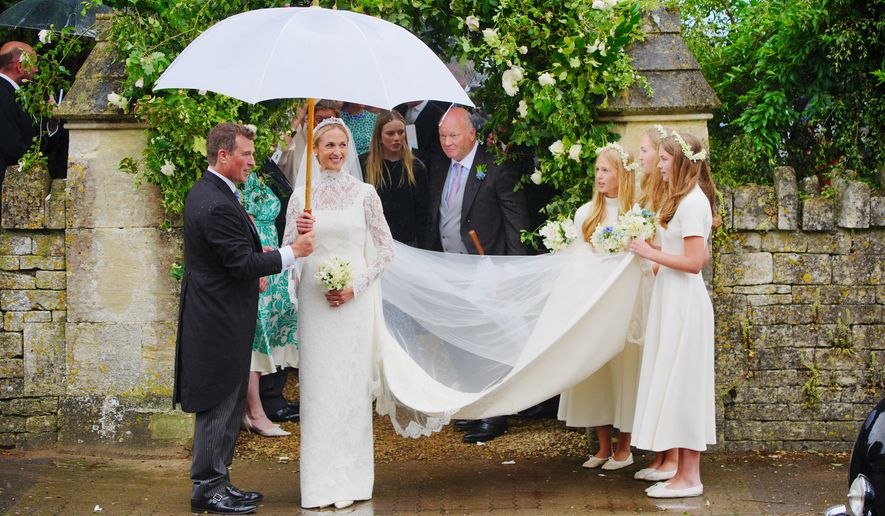 Bride Harriet Sperling and bride groom Peter Phillips, accompanied by bridesmaids after their wedding ceremony at All Saints Church in Kemble, Gloucestershire, England, Saturday, June 6, 2026. (Ben Birchall/PA via AP)