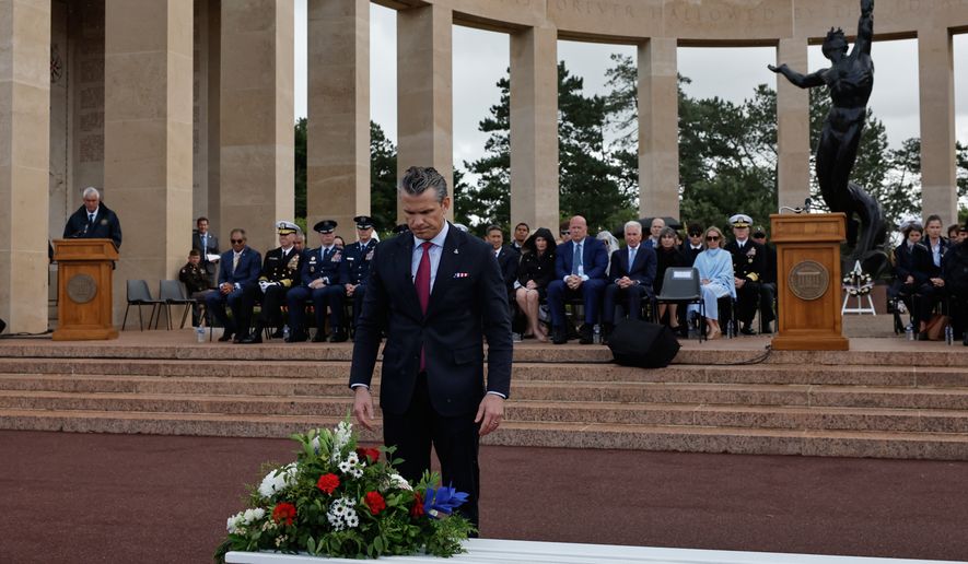 U.S. Defense Secretary Pete Hegseth lays a wreath of flowers during a ceremony at the US cemetery to commemorate the 82nd anniversary of the D-Day landings, in Colleville-sur-Mer, Normandy, France, Saturday, June 6, 2026. (AP Photo/Jeremias Gonzalez)