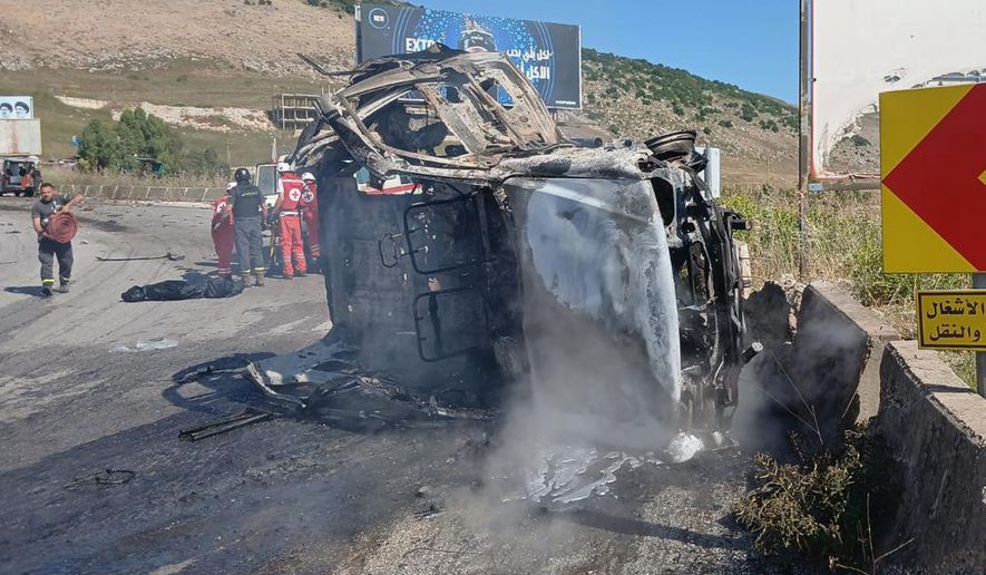 In this image released by the Lebanese Army on its official X account, Lebanese Red Cross personnel and rescue workers stand next to a destroyed vehicle after an Israeli airstrike on the road linking the city of Nabatiyeh and the town of Marjayoun, in Kfar Tebnit, Lebanon, Saturday, June 6, 2026, where, the Lebanese Army said, the vehicle belonged to the army and a brigadier general, a captain and another soldier were killed in the strike. (Lebanese Army via AP)