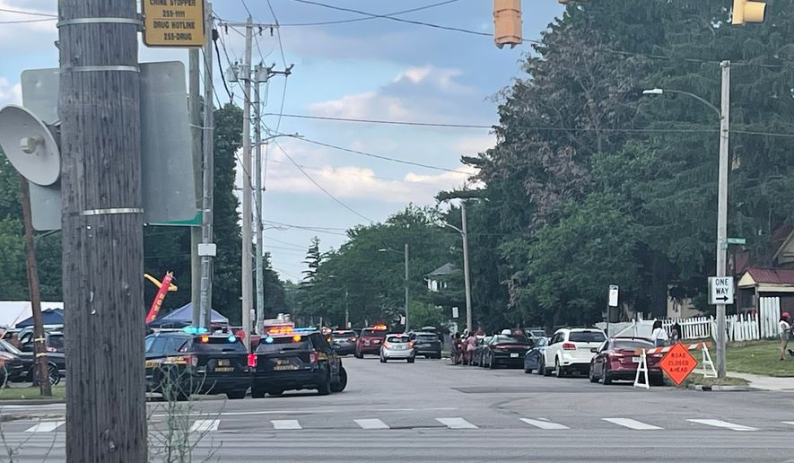 Police officers work at the scene of a shooting near a festival in Toledo, Ohio on Saturday, June 6, 2026. (WTVG via AP)