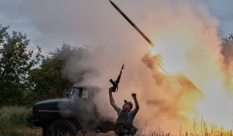 In this photo provided by Ukraine's 93rd Kholodnyi Yar Separate Mechanized Brigade press service, a soldier reacts as an MRLS BM-21 "Grad" fires at the Russian positions near Kostiantynivka, Donetsk region, Ukraine, Thursday, June 4, 2026. (Iryna Rybakova/Ukraine's 93rd Mechanized Brigade via AP)