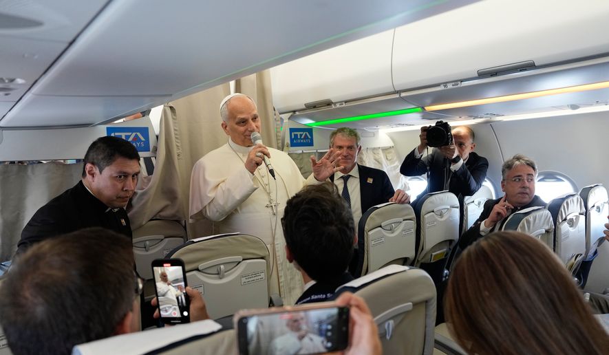 Pope Leo XIV talks to journalists aboard the papal flight from Rome to Madrid, Saturday, June 6, 2026, on the occasion of his apostolic journey to Spain. (AP Photo/Alessandra Tarantino, Pool)