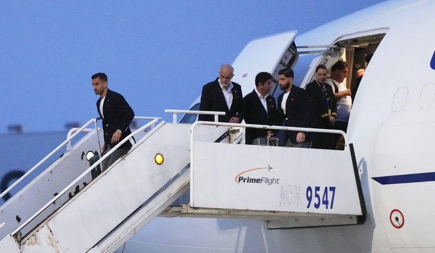 Iran's Ehsan Hajisafi, left, arrives with his teammates for the World Cup soccer tournament in Tijuana, Mexico, Sunday, June 7, 2026. (AP Photo/Gregory Bull)
