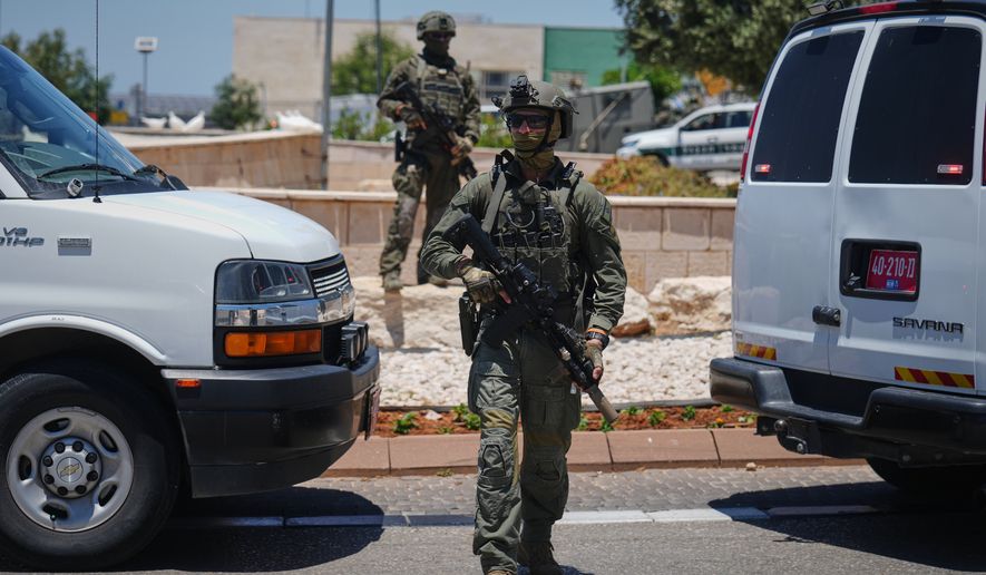 Israeli security forces are deployed at the scene of a shooting attack carried out by a Palestinian citizen of Israel near Tzur Yitzhak in central Israel, Sunday, June 7, 2026. (AP Photo/Ariel Schalit)