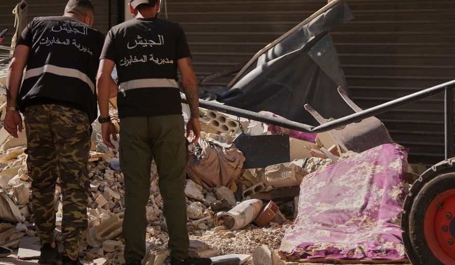 Lebanese intelligence officers look at an unexploded missile, centre, at the site where an Israeli airstrike hit a building in Dahiyeh, Beirut's southern suburb, Lebanon, Sunday, June 7, 2026. (AP Photo/Hassan Ammar)