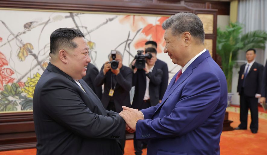 In this photo provided by the North Korean government, North Korean leader Kim Jong-un, left, shakes hands with Chinese President Xi Jinping in Beijing Thursday, Sept. 4, 2025. Independent journalists were not given access to cover the event depicted in this image distributed by the North Korean government. The content of this image is as provided and cannot be independently verified. Korean language watermark on image as provided by source reads: "KCNA" which is the abbreviation for Korean Central News Agency. (Korean Central News Agency/Korea News Service via AP, File)