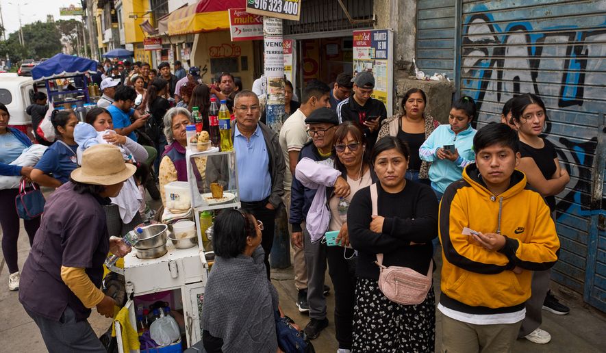 People line up to collect their national identity cards ahead of Peru's presidential runoff election in Lima, Peru, Saturday, June 6, 2026. (AP Photo/Rodrigo Abd)