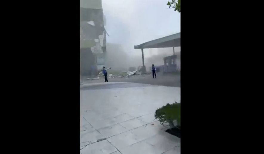 This image from a video shows dust and debris outside a building after a powerful earthquake in General Santos city on the island of Mindanao, Philippines Monday, June 8, 2026. (Ernesto Torres Jr via AP)