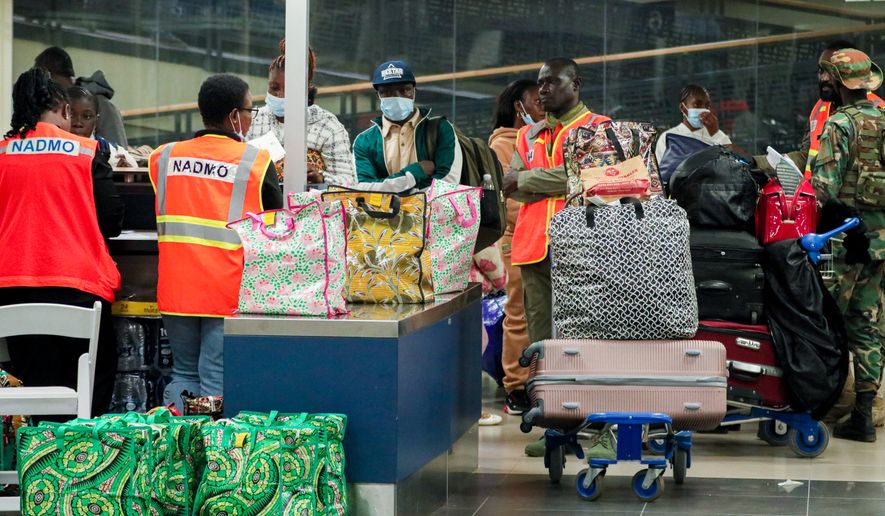 The National Disaster Management Organisation (NADMO) assists Ghanaian nationals repatriated from South Africa upon their arrival at the Accra International Airport in Accra, Ghana, Wednesday, May 27, 2026. (AP Photo/Tsraha Yaw)