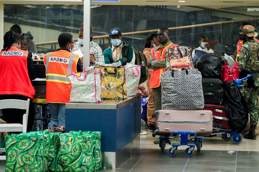 The National Disaster Management Organisation (NADMO) assists Ghanaian nationals repatriated from South Africa upon their arrival at the Accra International Airport in Accra, Ghana, Wednesday, May 27, 2026. (AP Photo/Tsraha Yaw)