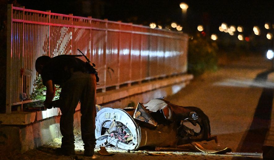 Israeli security forces examine a fragment of an intercepted Iranian missile in northern Israel, early Monday, June 8, 2026. (AP Photo/Rami Shlush)
