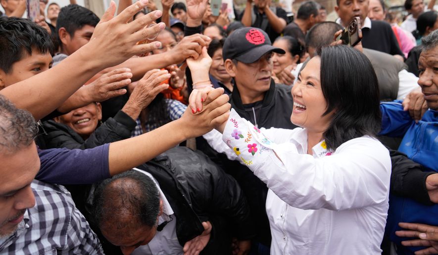 Presidential candidate Keiko Fujimori, of the Popular Force party, greets supporters before voting in the presidential runoff election in Lima, Peru, Sunday, June 7, 2026. (AP Photo/Martin Mejia)