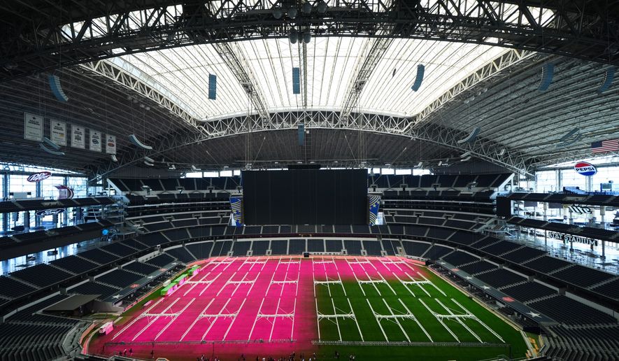 Grow lights illuminate part of the field at AT&T Stadium during a preview of the grass installed at Dallas Stadium in Arlington, Texas, on Thursday, May 14, 2026, ahead of the 2026 FIFA World Cup soccer tournament. (AP Photo/Julio Cortez) **FILE**