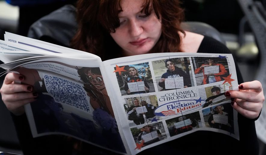 FILE - Columbia College Chicago student Kailey Ryan reads a newspaper in Chicago, Nov. 5, 2024. (AP Photo/Nam Y. Huh, File)