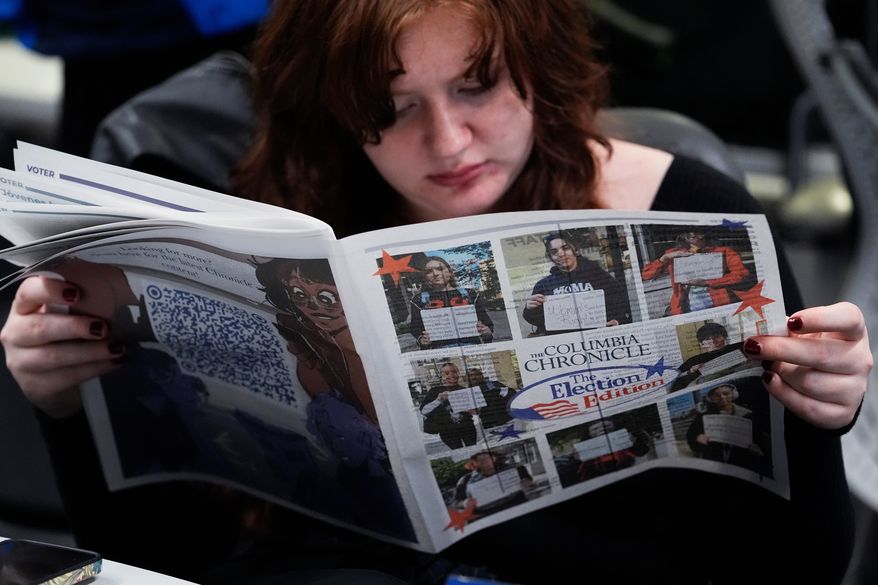 FILE - Columbia College Chicago student Kailey Ryan reads a newspaper in Chicago, Nov. 5, 2024. (AP Photo/Nam Y. Huh, File)