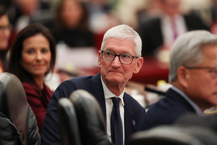 Apple CEO Tim Cook attends a meeting between Chinese Premier Li Qiang and U.S. business representatives, at the Great Hall of the People in Beijing, Thursday, May 14, 2026. (Go Nakamura/Pool Photo via AP)
