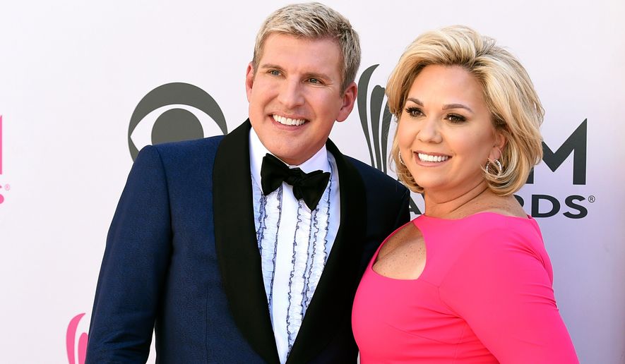 Julie Chrisley, right, and her husband Todd Chrisley pose for photos at the 52nd annual Academy of Country Music Awards in Las Vegas April 2, 2017. (Jordan Strauss/Invision/AP, File)