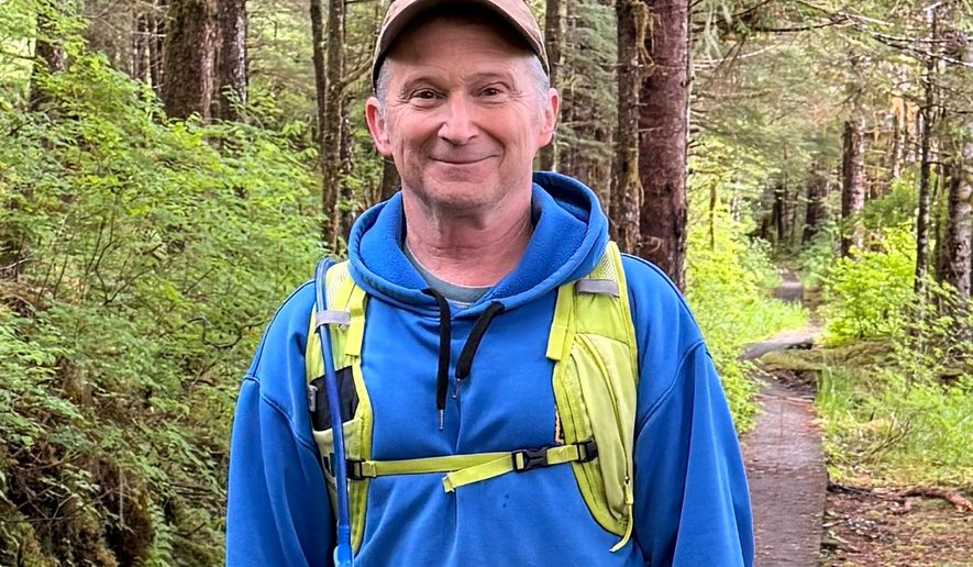 In this image provided by Karen Dillman, Alaska Senate candidate Dan Sullivan, one of the challengers to the incumbent senator, also named Dan Sullivan, poses for a photo on a hike, Sunday, June 7, 2026, on Kupreanof Island, near Petersburg, Alaska. (Karen Dillman via AP)