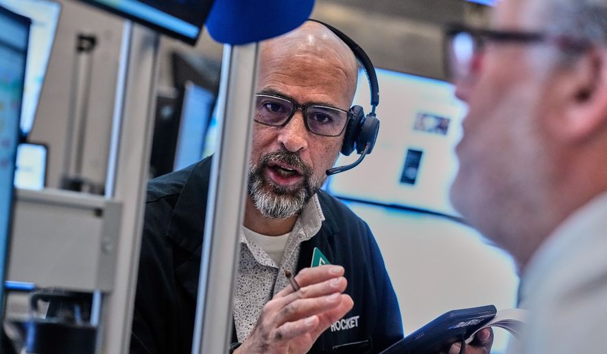 Options traders Steven Rodriguez, left, and Marty Handler work on the floor of the New York Stock Exchange, Wednesday, June 3, 2026. (AP Photo/Richard Drew)