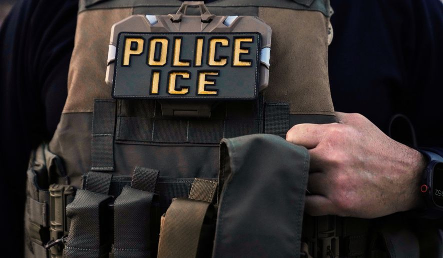 A U.S. Immigration and Customs Enforcement agent is seen in Park Ridge, Ill., Sept. 19, 2025. (AP Photo/Erin Hooley, File)