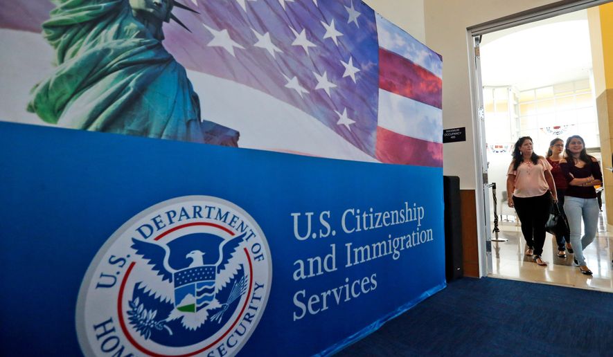 In this Aug. 17, 2018, file photo, people arrive before the start of a naturalization ceremony at the U.S. Citizenship and Immigration Services Miami Field Office in Miami. (AP Photo/Wilfredo Lee, File)