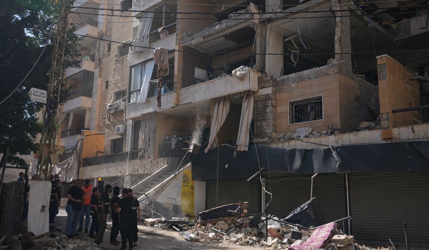 Lebanese security officers gather at the site where an Israeli airstrike hit a building in Dahiyeh, Beirut's southern suburb, Lebanon, Sunday, June 7, 2026. (AP Photo/Hassan Ammar)