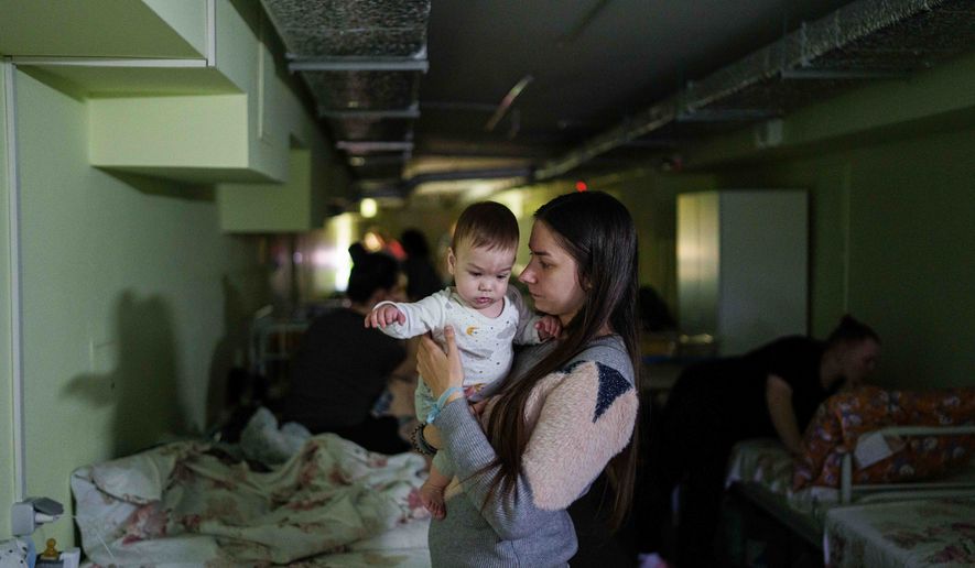 Marharyta Nekhoroshyva holds her son Mark inside a shelter at the children's regional hospital of Zaporizhzhia, Ukraine, on Thursday, May 7, 2026. (AP Photo/Evgeniy Maloletka)