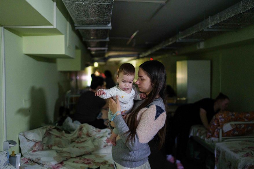 Marharyta Nekhoroshyva holds her son Mark inside a shelter at the children's regional hospital of Zaporizhzhia, Ukraine, on Thursday, May 7, 2026. (AP Photo/Evgeniy Maloletka)