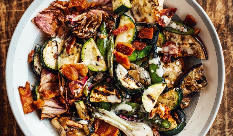 This image released by Voracious shows a recipe for grilled garden vegetables with bacon vinaigrette from the cookbook "Chasing the Gator" by Isaac Toups and Jennifer V. Cole. (Denny Culbert/Voracious via AP)