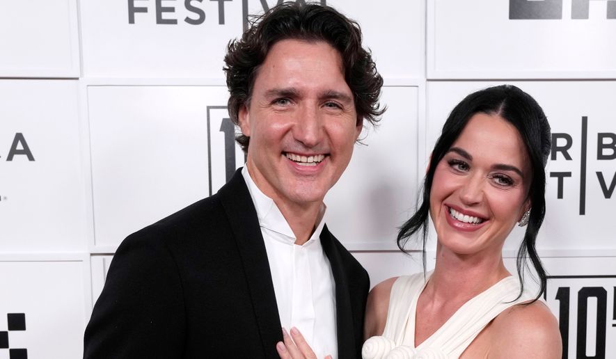 Justin Trudeau, left, and Katy Perry attend the "Katy Perry: The Lifetimes Tour - Live from Paris" world premiere at the OKX Theater at BMCC Tribeca Performing Arts Center during the Tribeca Festival on Monday, May 8, 2026, in New York. (Photo by Charles Sykes/Invision/AP)