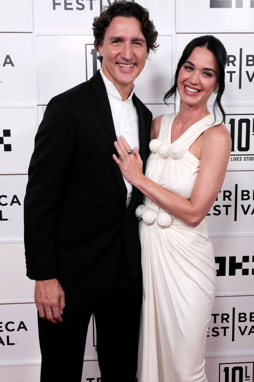 Justin Trudeau, left, and Katy Perry attend the "Katy Perry: The Lifetimes Tour - Live from Paris" world premiere at the OKX Theater at BMCC Tribeca Performing Arts Center during the Tribeca Festival on Monday, May 8, 2026, in New York. (Photo by Charles Sykes/Invision/AP)