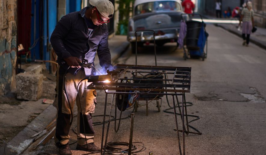 A blacksmith welds a door in Havana, Cuba, Tuesday, June 9, 2026. (AP Photo/Ramon Espinosa)