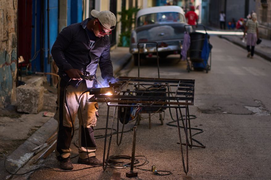 A blacksmith welds a door in Havana, Cuba, Tuesday, June 9, 2026. (AP Photo/Ramon Espinosa)