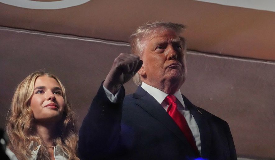 President Donald Trump gestures during the National Anthem as he attends an NBA Finals playoff basketball game between the New York Knicks and the San Antonio Spurs at Madison Square Garden in New York, Monday, June 8, 2026, with Kai Trump, left. (AP Photo/Mark Schiefelbein)