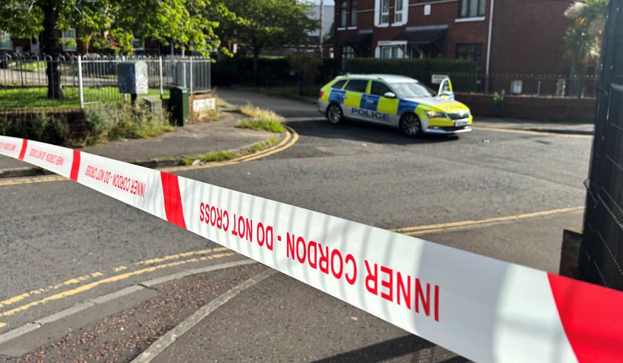A police cordon at the scene of a stabbing outside apartments in north Belfast, Tuesday, June 3, 2026. (Rebecca Black/PA via AP)