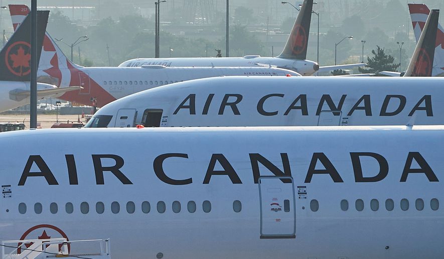 FILE - Air Canada planes sit on the runway at Pearson International Airport in Toronto on Aug. 16, 2025. (Sammy Kogan/The Canadian Press via AP, File)
