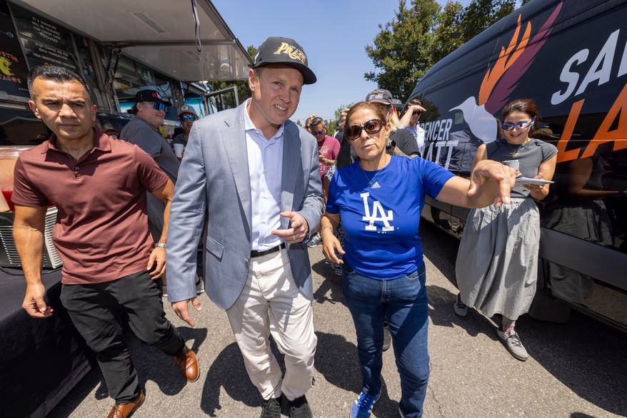 Los Angeles mayoral candidate Spencer Pratt gets shown around the neighborhood by Maggie Quiroz during a campaign event Sunday, May 31, 2026, in Los Angeles. (AP Photo/Jill Connelly)