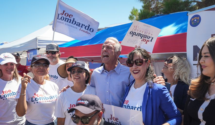 Nevada Gov. Joe Lombardo, center, poses with supporters outside a vote center Tuesday, June 9, 2026, in Las Vegas. (AP Photo/Jae C. Hong)