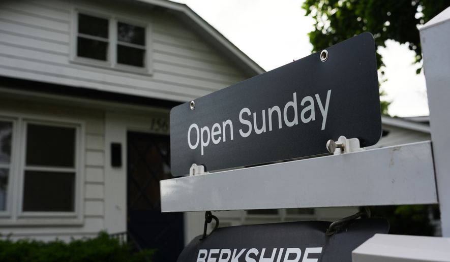 Information sign about open house for home sale is seen outside of a home in Wheeling, Ill., Monday, June 8, 2026. (AP Photo/Nam Y. Huh)