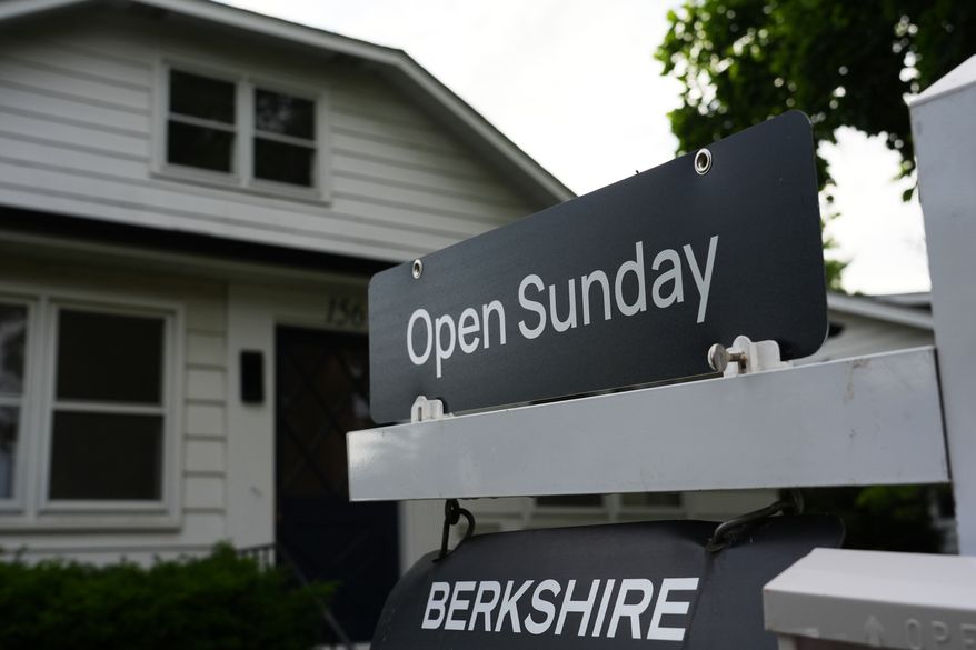 Information sign about open house for home sale is seen outside of a home in Wheeling, Ill., Monday, June 8, 2026. (AP Photo/Nam Y. Huh)